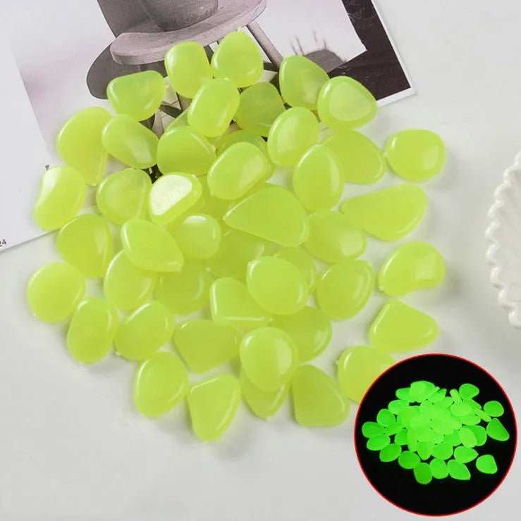 Luminous fluorescent aquarium and garden pebbles in mixed colours including dark purple, yellow, light blue, pink, orange