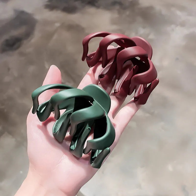 Children's plastic hair clip in small size available in green, dark blue, wine red, black, dark pink, and blue gray.