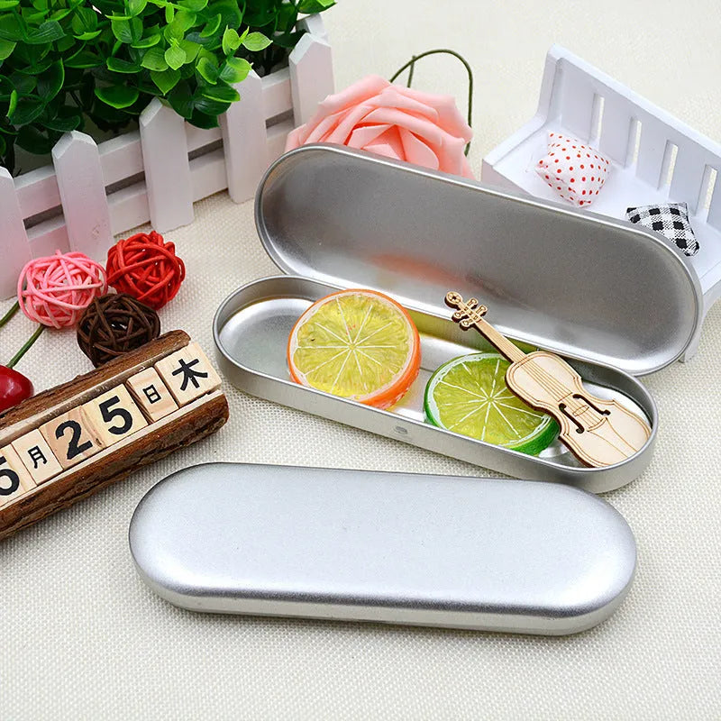 Rectangular frosted tinplate metal box for pen and cosmetic storage.