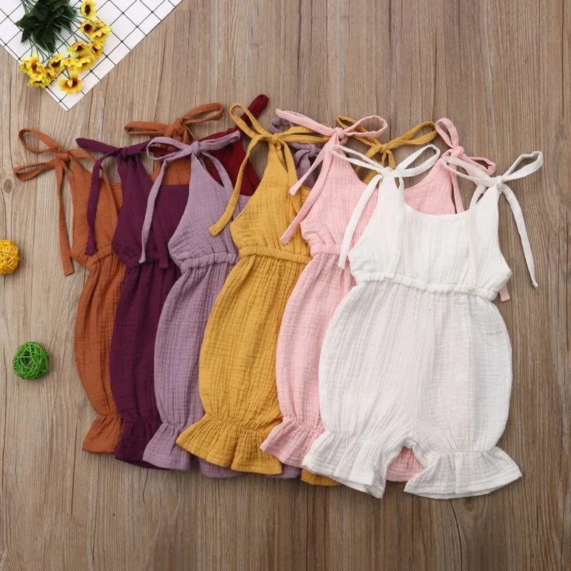 Baby girls sleeveless solid cotton romper jumpsuit in pink, front view