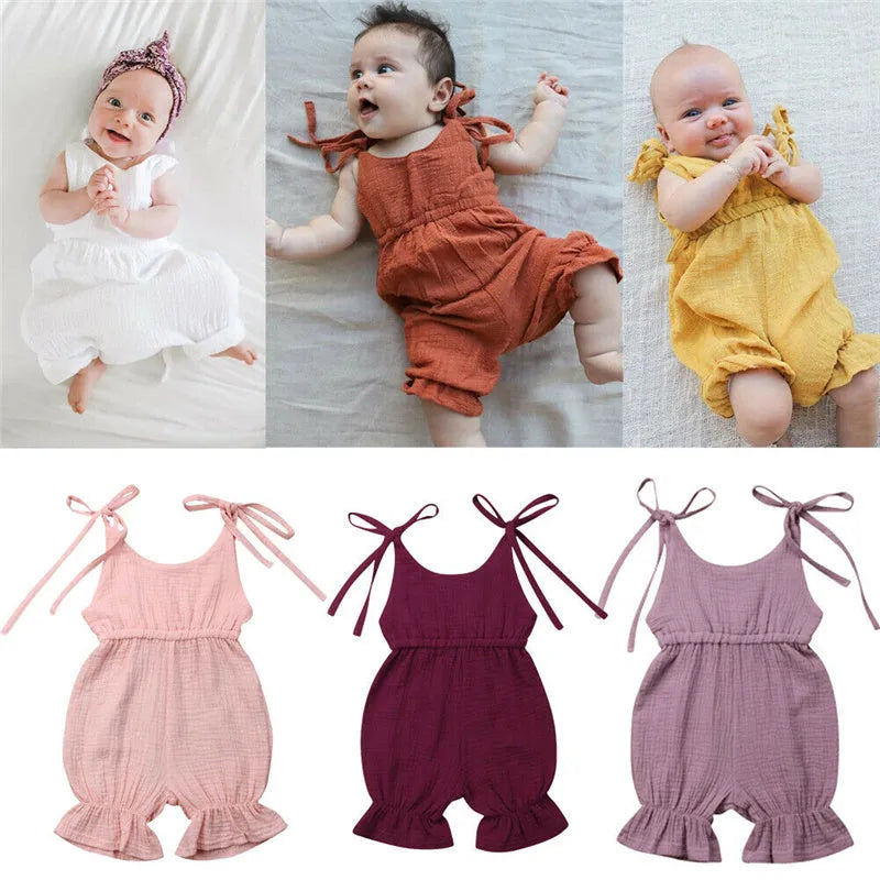 Baby girls sleeveless solid cotton romper jumpsuit in pink, front view