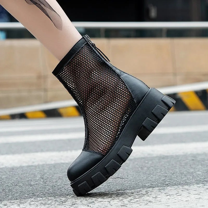 Women's black PU Roman sandals with rear zipper and round toe on a light background, side view.