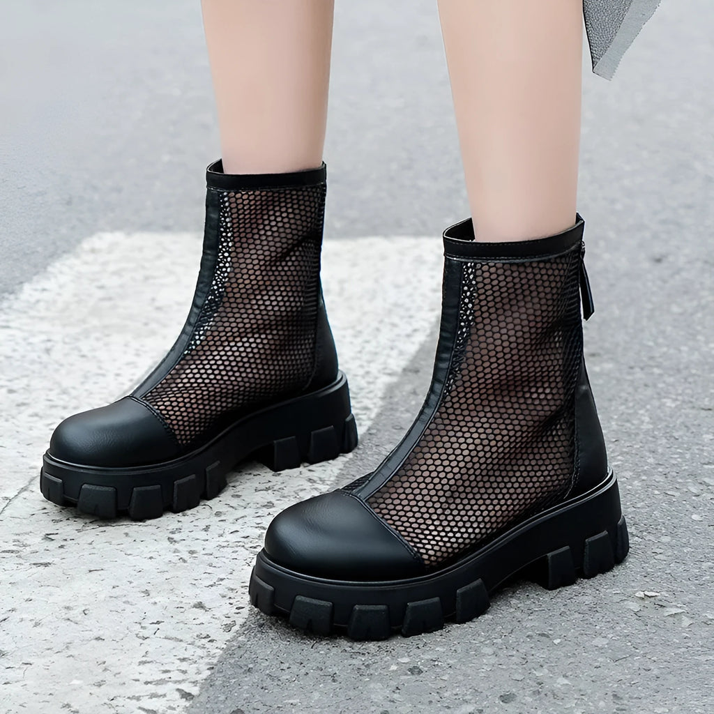 Women's black PU Roman sandals with rear zipper and round toe on a light background, side view.