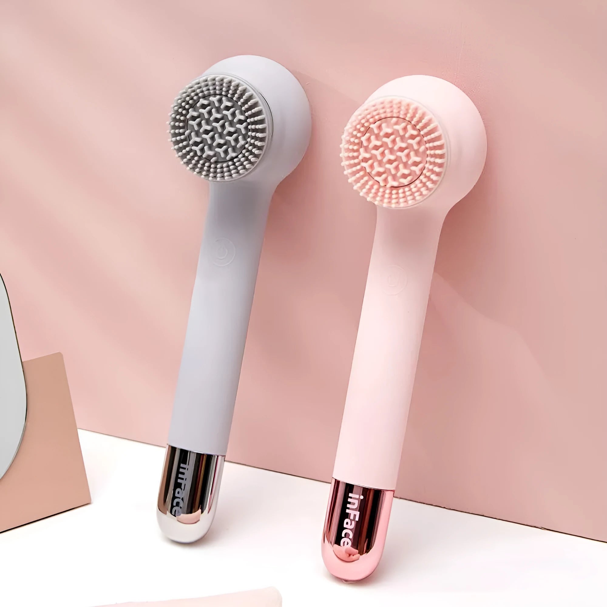 Grey and pink electric shower brush with rotating massage heads