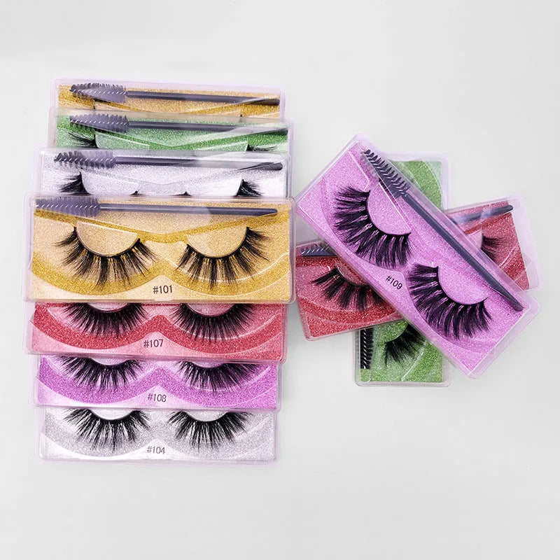 One pair of natural 3D imitation mink false eyelashes in elongated eye tail style with a brush on a white background