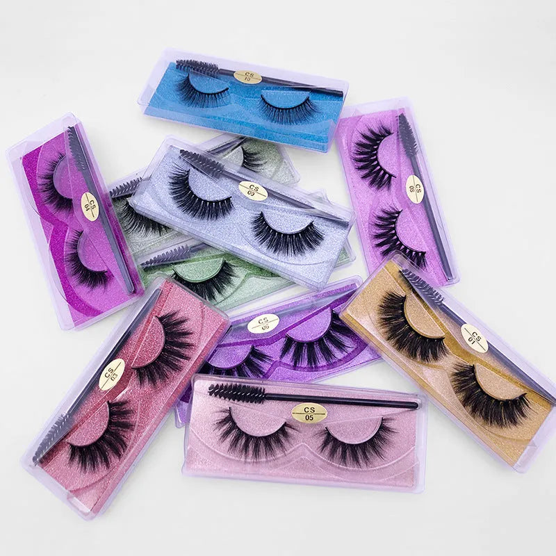 One pair of natural 3D imitation mink false eyelashes in elongated eye tail style with a brush on a white background