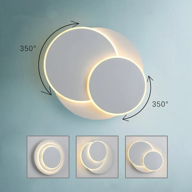 Modern round white acrylic LED wall lamp with push button switch mounted on a wall.