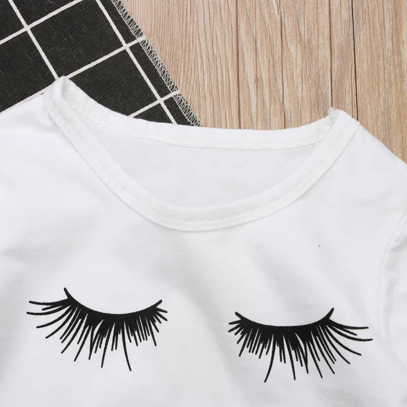 Pudcoco white two-piece girl set with eyelash short-sleeve top and ripped trousers on child model