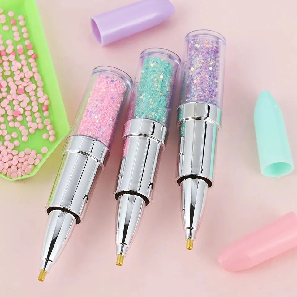 A green plastic point drill pen for diamond painting placed on a craft table.