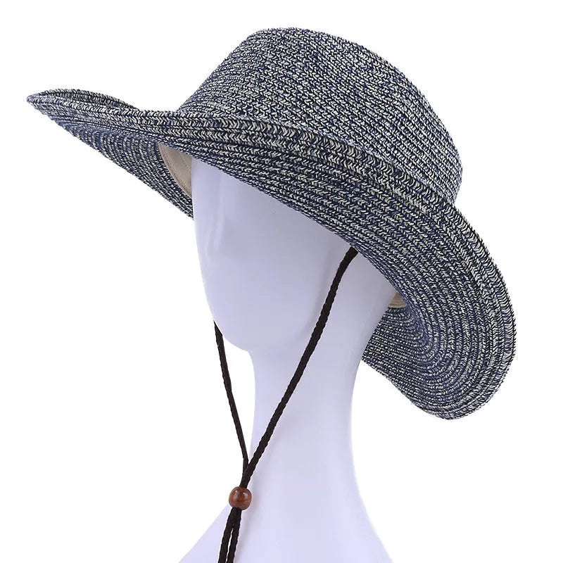 Unisex papyrus wide brim sun hat with adjustable wind lanyard in grey, shown on a beach background
