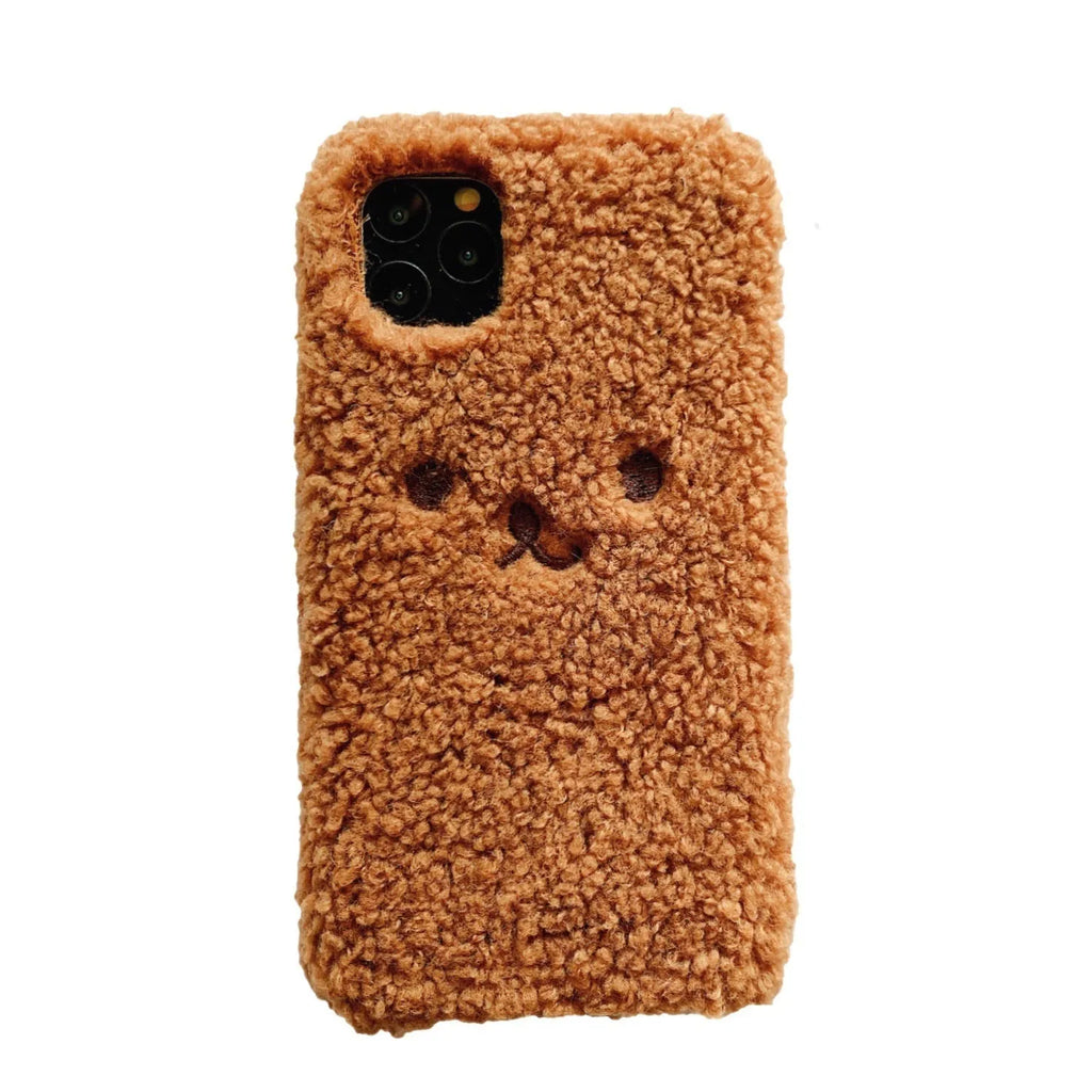 Brown embroidered plush cartoon bear face on a flexible iPhone phone case.