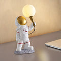 White astronaut desk lamp with night light function in seated, standing and wall-mounted styles