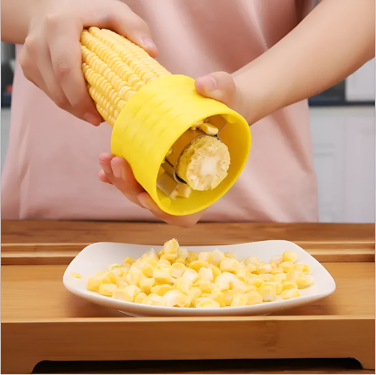 Yellow manual corn grinder thresher kitchen tool with corn-shaped design and stainless steel gear.
