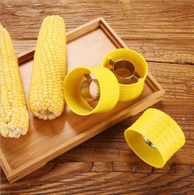 Yellow manual corn grinder thresher kitchen tool with corn-shaped design and stainless steel gear.