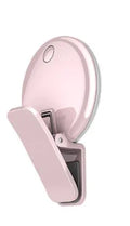 Circular mobile phone selfie ring light attached to smartphone providing frontal illumination