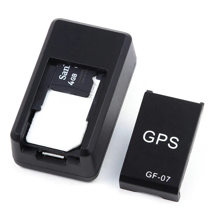 Small black plastic magnetic GPS tracker device next to a USB charging cable.