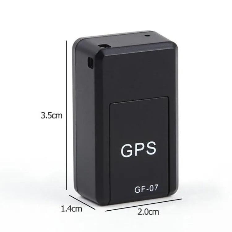Small black plastic magnetic GPS tracker device next to a USB charging cable.
