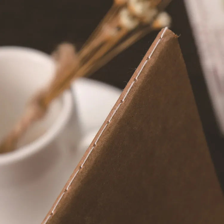 80g kraft paper notebook with blank pages, beige Dao Lin paper, and car thread stitch binding shown open on a flat surface