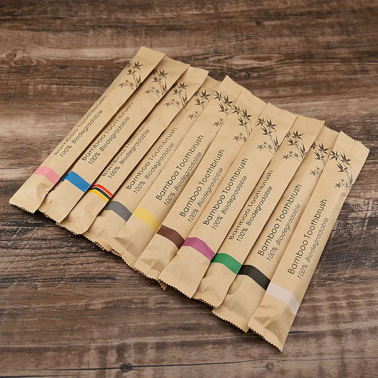 Set of 10 bamboo toothbrushes in multiple colours showing natural bamboo handles and soft bristles