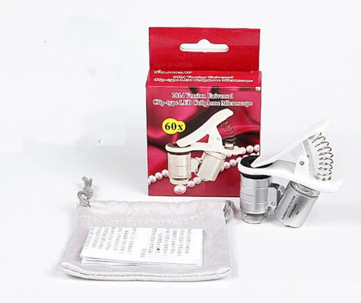 White 60X universal mobile phone clip magnifier attached to smartphone camera for macro photography
