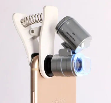 White 60X universal mobile phone clip magnifier attached to smartphone camera for macro photography