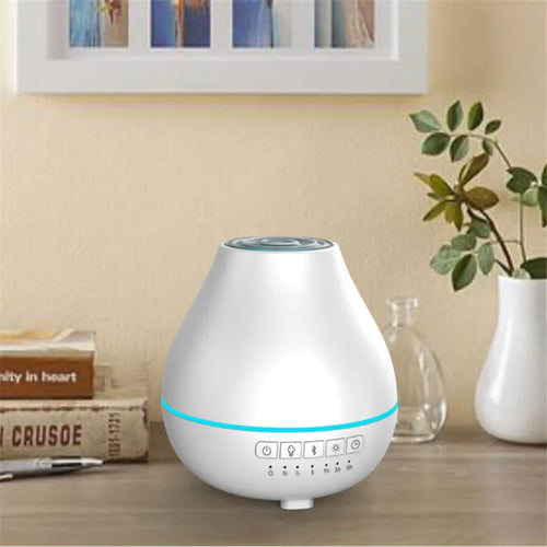 White round Bluetooth humidifier and aroma diffuser with night light on wooden surface