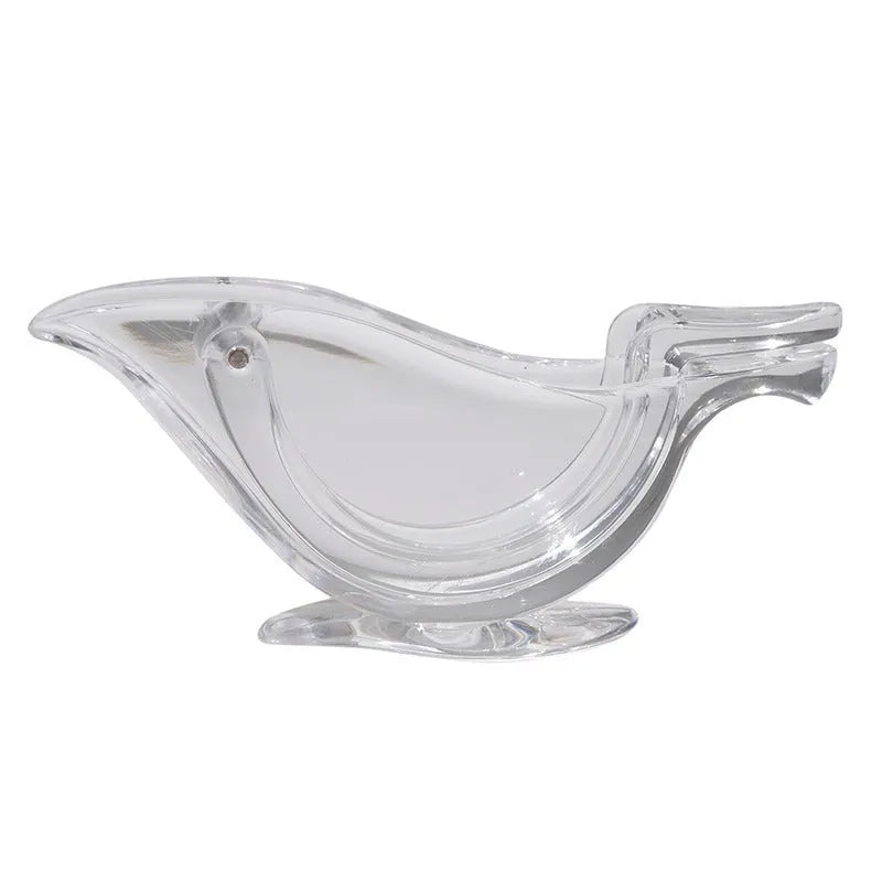 Clear acrylic bird-shaped manual lemon juicer on a kitchen counter