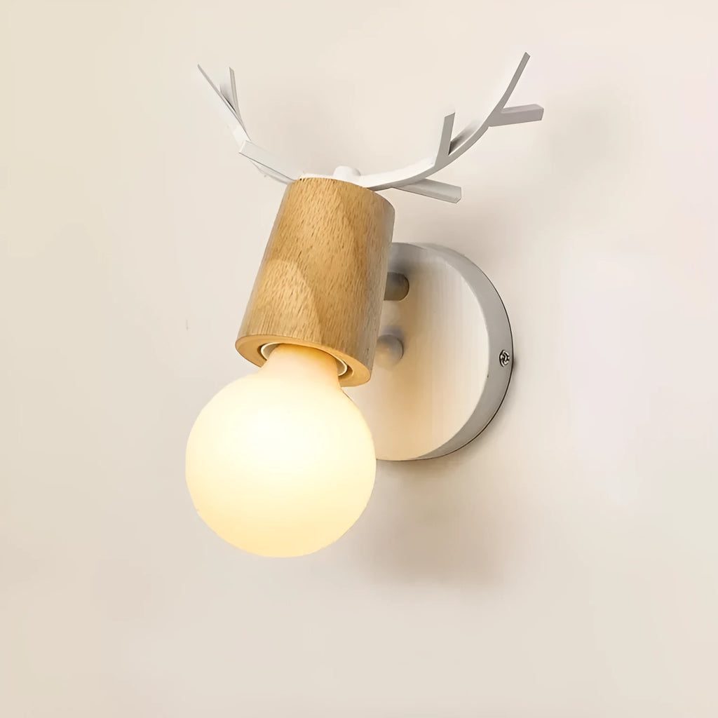 Wrought iron wall lamp with wooden antler-style shade on a white wall