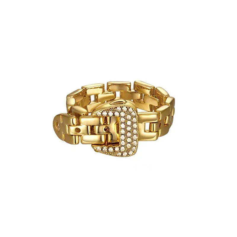 Gold adjustable belt buckle zircon ring with detachable metal chain on women's hand against light background