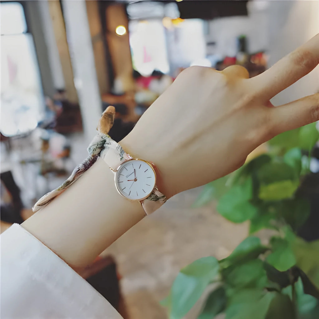 Retro art women tie watch with round alloy case and cloth strap in pink