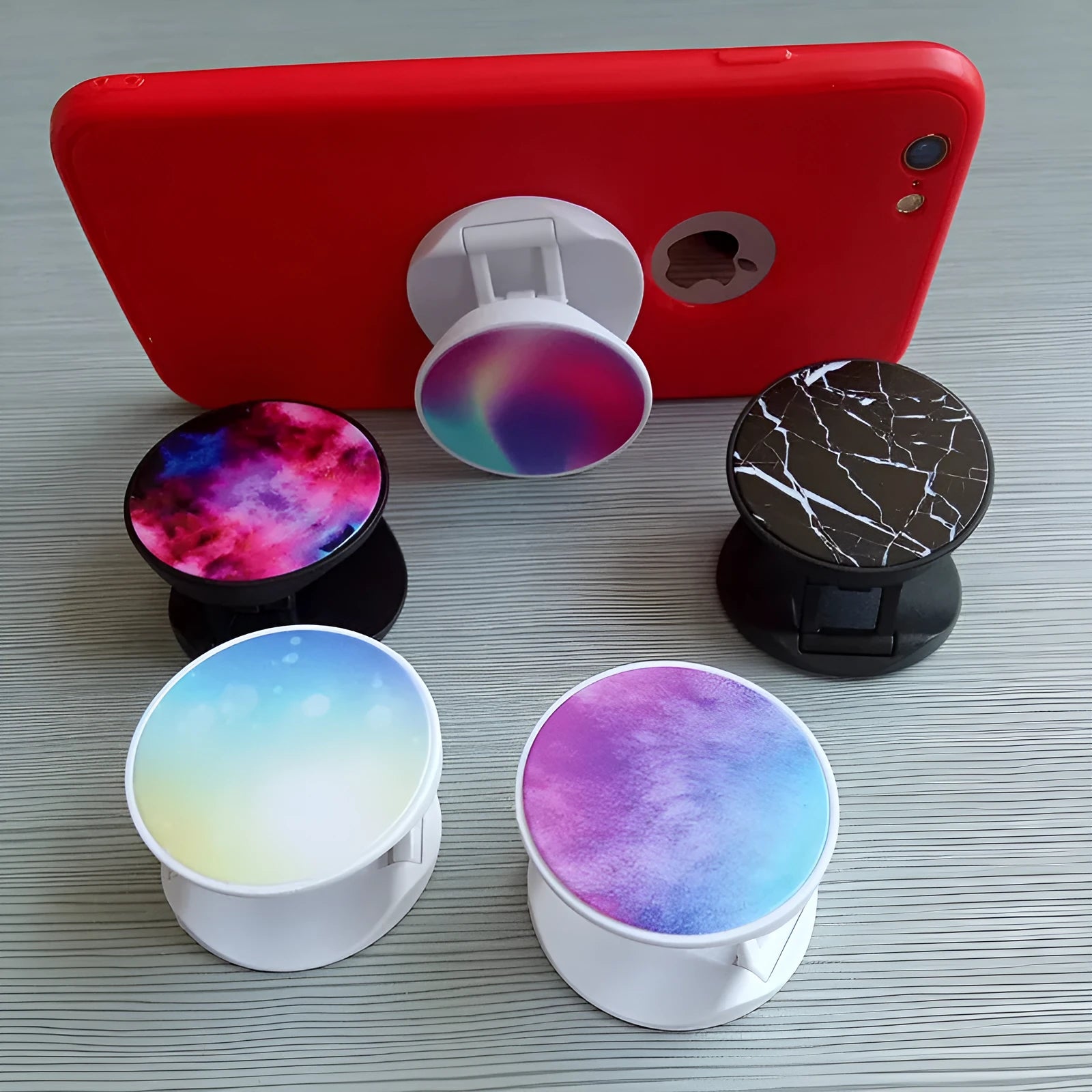 Folding mobile phone stand on desktop showing thermal transfer aluminium sheet variant