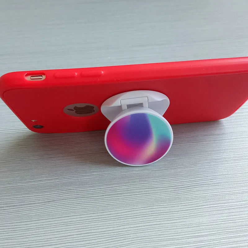 Folding mobile phone stand on desktop showing thermal transfer aluminium sheet variant