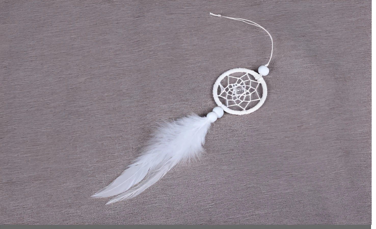 White mini dreamcatcher pendant 5cm on a wall as home decor