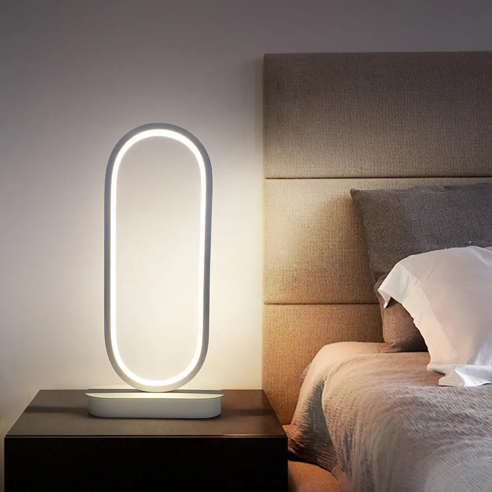 Oval metal table lamp with black finish, LED light, 45cm height, on a wooden surface