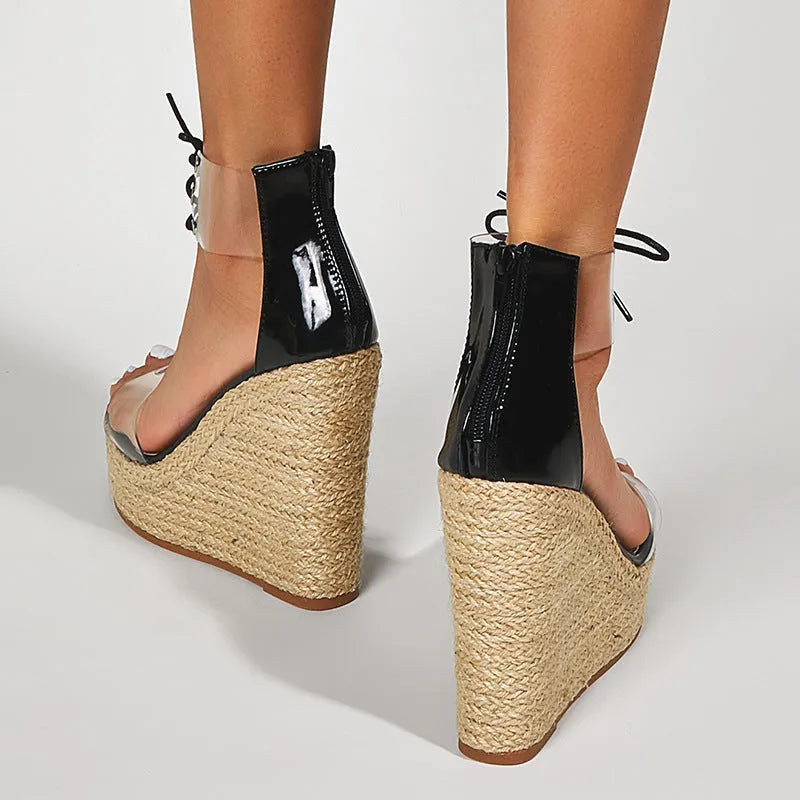 Black women's wedge sandals with hemp rope front tie on a super high platform heel.