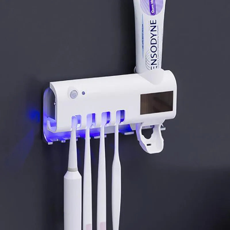 Black intelligent UV toothbrush steriliser and automatic toothpaste squeezer unit mounted on a bathroom wall.