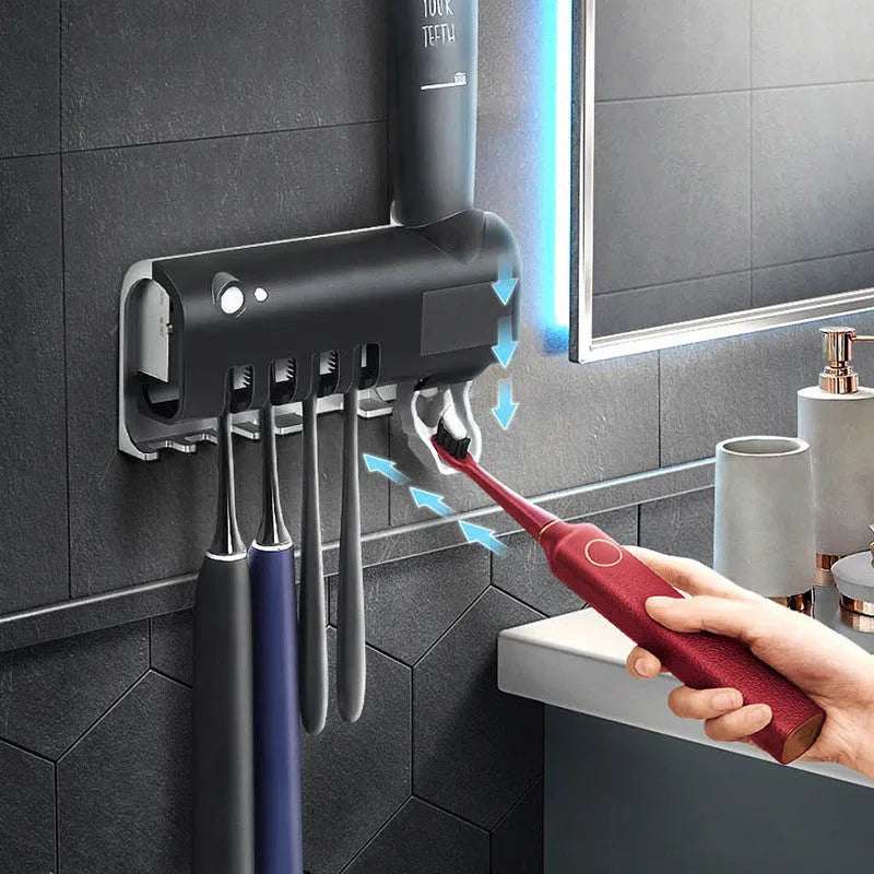 Black intelligent UV toothbrush steriliser and automatic toothpaste squeezer unit mounted on a bathroom wall.