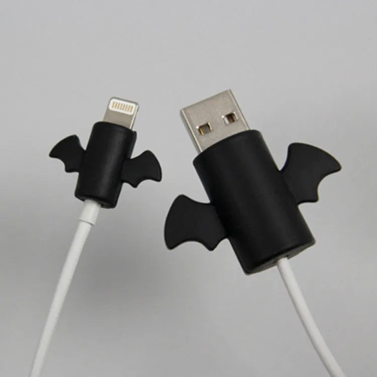 White and black silicone cable protective covers shown next to mobile phone charging cable