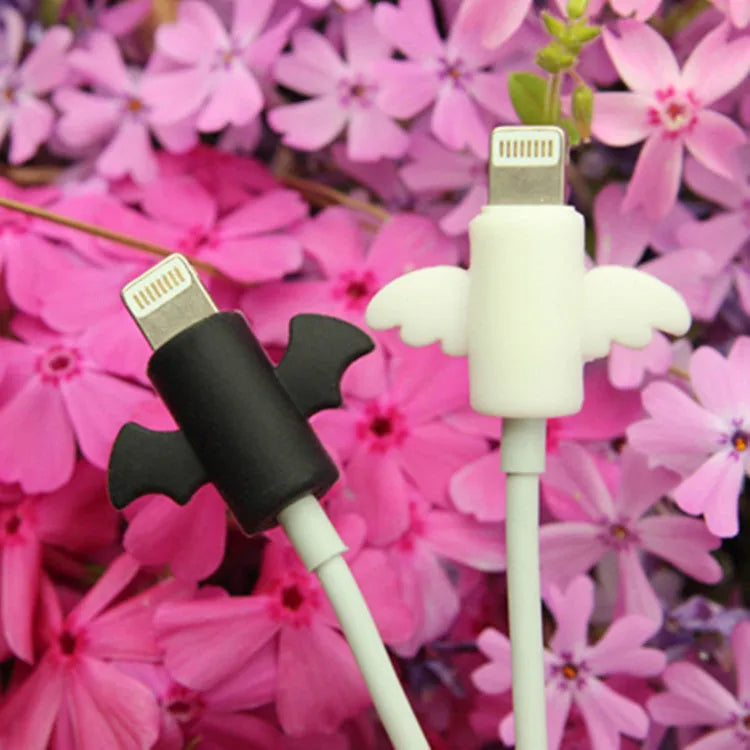 White and black silicone cable protective covers shown next to mobile phone charging cable