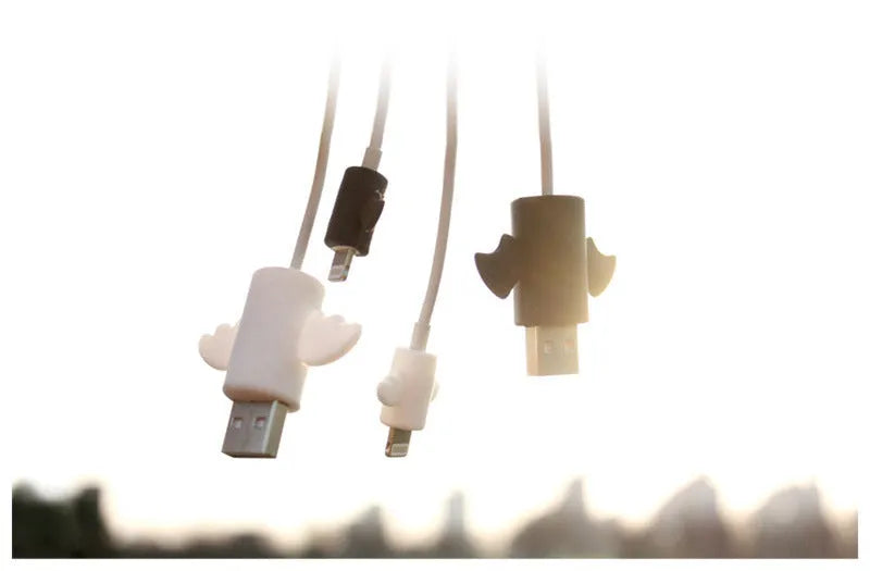 White and black silicone cable protective covers shown next to mobile phone charging cable