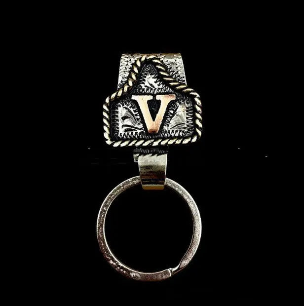 Handmade metal cow tag style key holder shown in one of its 26 colour options, attached to a keyring.