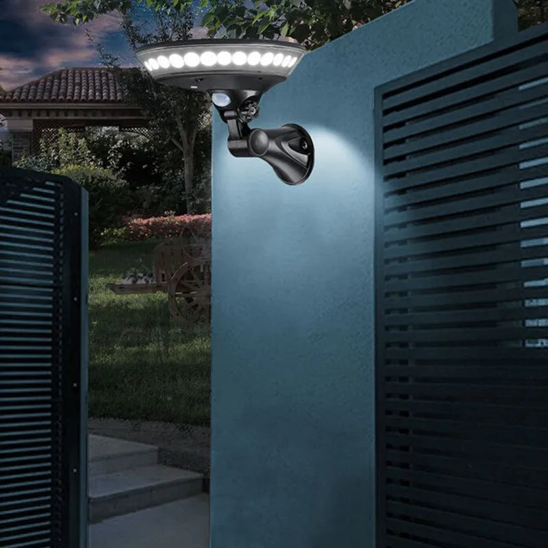 White solar-powered outdoor light with 360-degree LEDs and a top-mounted solar panel on a stake.
