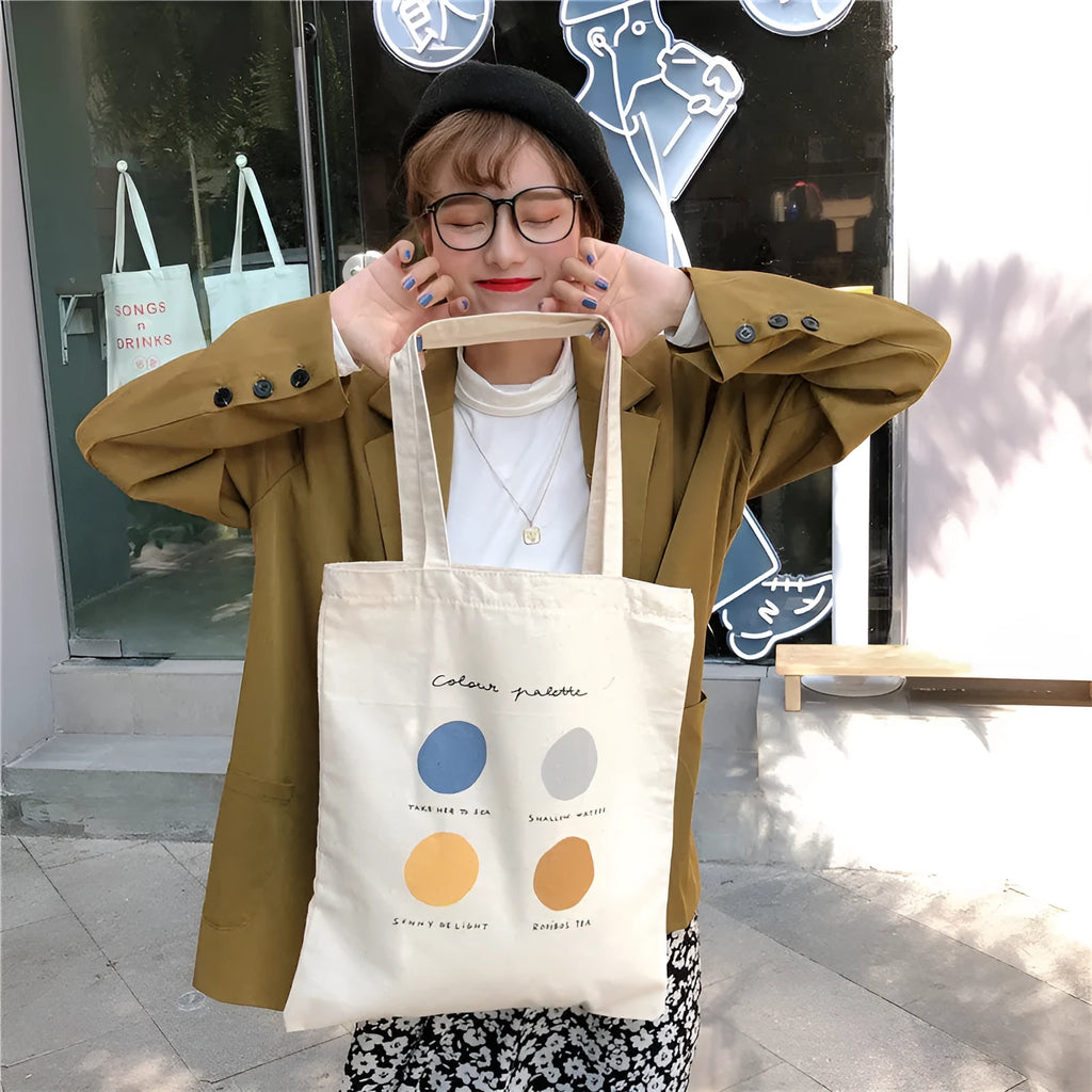 Orange geometric print women's canvas tote bag with zip top and shoulder straps.