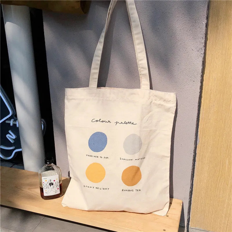 Orange geometric print women's canvas tote bag with zip top and shoulder straps.