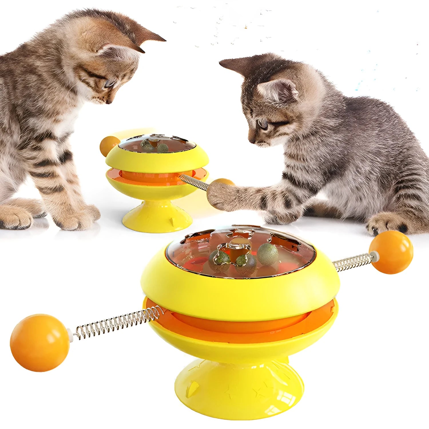 Rotating turntable cat toy with transparent compartment containing catnip balls and suction cup base