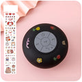 Cute waterproof Bluetooth mini speaker with suction cup on a tiled bathroom wall, available in multiple colours