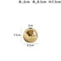 Handmade ceramic gold electroplated spherical vase on a table as home decor
