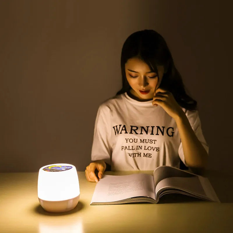 Pruixin PRX1363 rotating LED projector night light showing starry sky patterns on a wall.