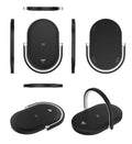 Black wireless charging pad with night light and integrated phone holder on a wooden desk.