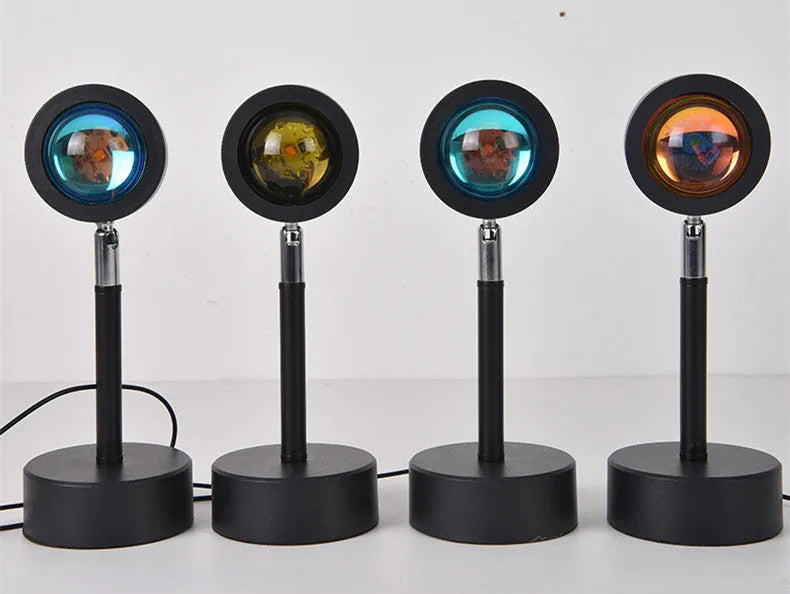 WiFi LED sunset projector light with 16 RGB colours, 360° rotation, glass lampshade, and touch switch on a table